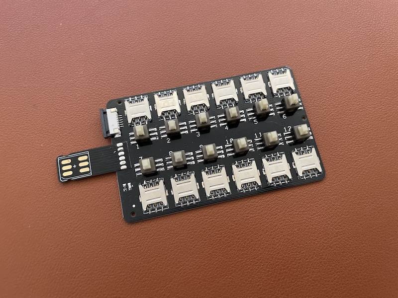 A multi-SIM adapter with twelve SIM card slots.